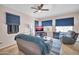Comfortable living room with tile floor, ceiling fan, and plentiful natural light from large windows at 12022 W Belmont W Dr, Avondale, AZ 85323