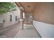 Inviting covered front porch with stone pillar accents and a secure screen door entrance at 12022 W Belmont W Dr, Avondale, AZ 85323