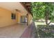 Cozy covered back patio featuring tile flooring, a ceiling fan, and views of the landscaped backyard at 13012 N 26Th Dr, Phoenix, AZ 85029