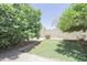 Tranquil backyard featuring mature trees, gravel accents, and a tidy lawn, creating a serene outdoor space at 13012 N 26Th Dr, Phoenix, AZ 85029
