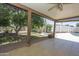 Inviting covered patio with ceiling fan, overlooking the spacious backyard and sparkling pool, perfect for outdoor entertaining at 13012 N 26Th Dr, Phoenix, AZ 85029
