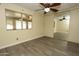 Bright bedroom features mirrored closet doors, a ceiling fan and flooring at 13012 N 26Th Dr, Phoenix, AZ 85029