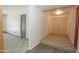 Welcoming home foyer featuring tile flooring, a modern light fixture, and a neutral color palette at 13012 N 26Th Dr, Phoenix, AZ 85029