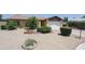 Well-maintained home featuring desert landscaping including gravel, bushes and trees in circular beds at 13012 N 26Th Dr, Phoenix, AZ 85029