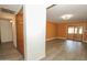 Open-concept living room featuring wood-look flooring, a sliding glass door, and ample natural light at 13012 N 26Th Dr, Phoenix, AZ 85029