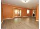 Spacious living room featuring wood-look flooring, a sliding glass door, and a view to an adjacent room at 13012 N 26Th Dr, Phoenix, AZ 85029