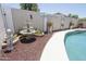 Poolside decor featuring a water fountain, lawn ornaments, and potted plants at 13012 N 26Th Dr, Phoenix, AZ 85029
