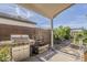 Outdoor kitchen area with stainless steel grill and covered patio, perfect for entertaining in the Arizona sunshine at 1396 E Leslie Ave, San Tan Valley, AZ 85140