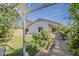 Well-manicured backyard featuring stepping stones, a lush lawn, and a cozy patio area, ideal for outdoor gatherings at 1396 E Leslie Ave, San Tan Valley, AZ 85140