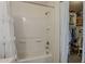 Bathroom features white shower-tub combination and a view to a walk-in closet at 1396 E Leslie Ave, San Tan Valley, AZ 85140