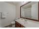 Bathroom featuring a vanity, sink, mirror, toilet, and shower-tub combo at 1396 E Leslie Ave, San Tan Valley, AZ 85140