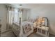 Cozy bedroom with carpet, white walls, decorative curtains, and a vintage style four poster bed at 1396 E Leslie Ave, San Tan Valley, AZ 85140