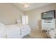 Bedroom features vaulted ceiling, ceiling fan, carpet, television, and white furniture at 1396 E Leslie Ave, San Tan Valley, AZ 85140