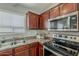 Kitchen area showcasing stainless steel appliances and wood cabinets with plenty of light at 1396 E Leslie Ave, San Tan Valley, AZ 85140