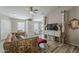 Cozy living room featuring tile floors, designer furniture, and natural light at 1396 E Leslie Ave, San Tan Valley, AZ 85140