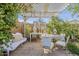 Charming outdoor dining area beneath a pergola, featuring vintage-inspired decor and ample seating at 1396 E Leslie Ave, San Tan Valley, AZ 85140