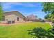 Spacious backyard with lush green lawn, a swimming pool and patio, perfect for outdoor living at 1420 W Raven Dr, Chandler, AZ 85286