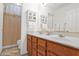 Bright bathroom featuring a double vanity with white countertops and a decorative mirror at 1420 W Raven Dr, Chandler, AZ 85286