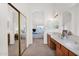A bright bathroom with dual sinks leading through a doorway to a bedroom featuring sliding door closet at 1420 W Raven Dr, Chandler, AZ 85286