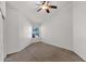 A simple bedroom that is well-lit from a window and has neutral walls and carpet, plus ceiling fan at 1420 W Raven Dr, Chandler, AZ 85286