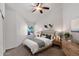 Bright bedroom features neutral colors, large window, fan, and wooden bedside table, creating a cozy atmosphere at 1420 W Raven Dr, Chandler, AZ 85286