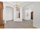 Clean dining area featuring a classic chandelier, archways, and minimalist decor, creating a bright and open space at 1420 W Raven Dr, Chandler, AZ 85286