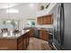 Bright kitchen with stainless appliances, island with barstool seating, and granite countertops at 1420 W Raven Dr, Chandler, AZ 85286
