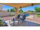 Relaxing covered patio featuring comfortable seating and a view of the inviting pool and backyard at 1420 W Raven Dr, Chandler, AZ 85286
