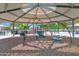 Community playground featuring swings and climbing structures under a covered shade at 1420 W Raven Dr, Chandler, AZ 85286