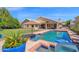 Beautiful backyard featuring a sparkling pool, spa, and lush landscaping, perfect for outdoor enjoyment at 1420 W Raven Dr, Chandler, AZ 85286