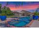 Backyard oasis with a sparkling pool, a spa and a lush green lawn, perfect for relaxation at 1420 W Raven Dr, Chandler, AZ 85286