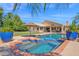 Backyard oasis with a sparkling pool, a spa and a lush green lawn, perfect for relaxation at 1420 W Raven Dr, Chandler, AZ 85286