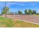 Community sand volleyball court with lush trees and a bright blue sky at 1420 W Raven Dr, Chandler, AZ 85286