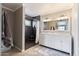 Modern bathroom with stylish vanity and walk-in shower featuring dark tile at 1670 E Whitten St, Chandler, AZ 85225