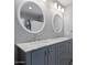 Bathroom featuring a double vanity with marble countertops, dual sinks, and gray cabinets at 1670 E Whitten St, Chandler, AZ 85225