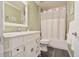 Charming bathroom with a vanity and a shower-tub combo with a decorative shower curtain at 1670 E Whitten St, Chandler, AZ 85225