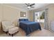 Cozy bedroom featuring a ceiling fan, plush carpeting, and a comfortable armchair at 1670 E Whitten St, Chandler, AZ 85225