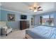 Cozy blue bedroom with a window view and plush armchair at 1670 E Whitten St, Chandler, AZ 85225