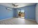Bright bedroom with wood-look tile flooring and slider doors to a patio or yard at 1670 E Whitten St, Chandler, AZ 85225