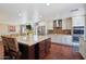 A modern, open-concept kitchen boasts stainless steel appliances, granite countertops, and custom cabinetry at 1670 E Whitten St, Chandler, AZ 85225