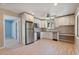 Modern kitchen with white cabinetry, stainless steel appliances, granite countertops, and wood-look tile at 1670 E Whitten St, Chandler, AZ 85225