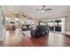 Spacious living room with hardwood floors, ceiling fans, and sliding glass doors to the backyard at 1670 E Whitten St, Chandler, AZ 85225