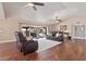 Open living area with hardwood floors, leather couches, and sliding glass doors to backyard at 1670 E Whitten St, Chandler, AZ 85225