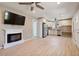 Open-concept living space with a fireplace, sleek floors, and a modern, fully equipped kitchen at 1670 E Whitten St, Chandler, AZ 85225