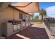 Beautiful outdoor kitchen with stainless steel appliances, granite countertops, and covered patio area at 1670 E Whitten St, Chandler, AZ 85225