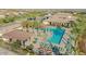 Aerial view of the community pool and amenities, including lounge areas and lush landscaping at 17219 W La Luz Rd, Surprise, AZ 85387
