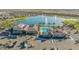 Aerial view of the community's lake, clubhouse, pool, and surrounding neighborhood at 17219 W La Luz Rd, Surprise, AZ 85387