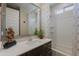 Bright bathroom featuring a white vanity, large mirror, and shower-tub combination at 17219 W La Luz Rd, Surprise, AZ 85387