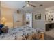 Bright bedroom with a ceiling fan, wardrobe, and view to the bathroom at 17219 W La Luz Rd, Surprise, AZ 85387