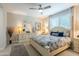Serene bedroom with soft lighting, a ceiling fan, and coordinated furnishings at 17219 W La Luz Rd, Surprise, AZ 85387